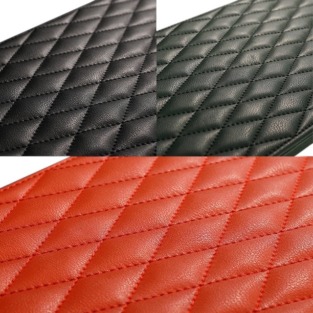 Gros plan sur le cuir matelassé noir, vert et orange du remontoir Maison Orvian Pégase pour trois montres.